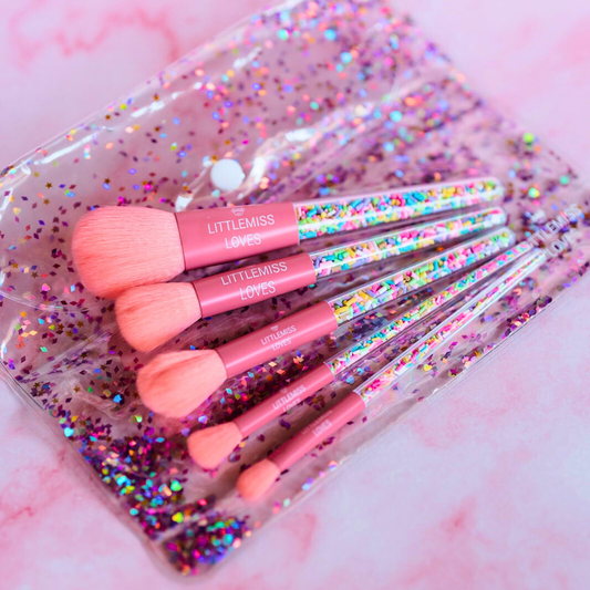 Set of pink makeup brushes with 'LITTLEMISS' branding in a glittery case.