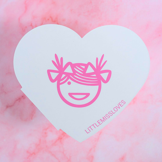 Heart-shaped eyeshadow palette with 'LITTLEMISSLOVES' branding on a pink marble background