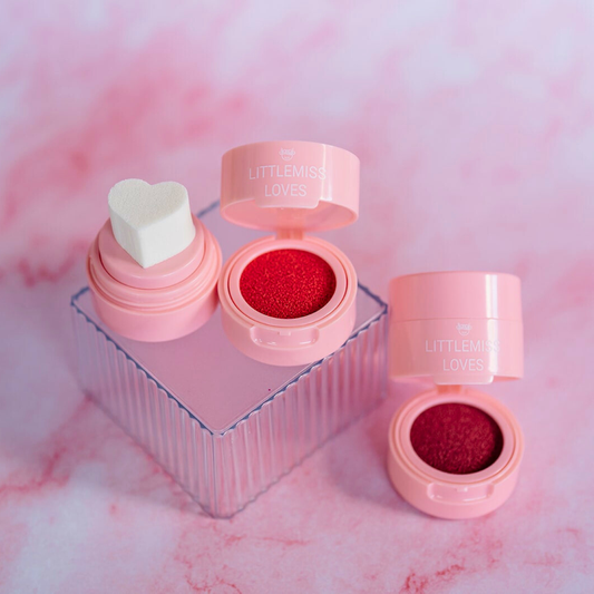Pink makeup product with heart-shaped container on a pink marble background