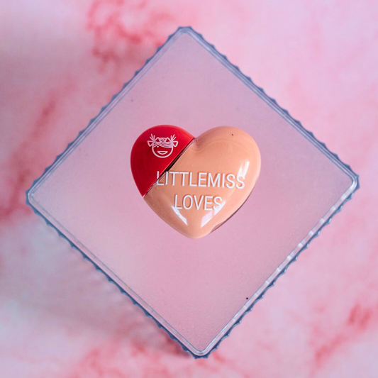 Heart-shaped product with 'LITTLEMISS LOVES' branding on a pink background