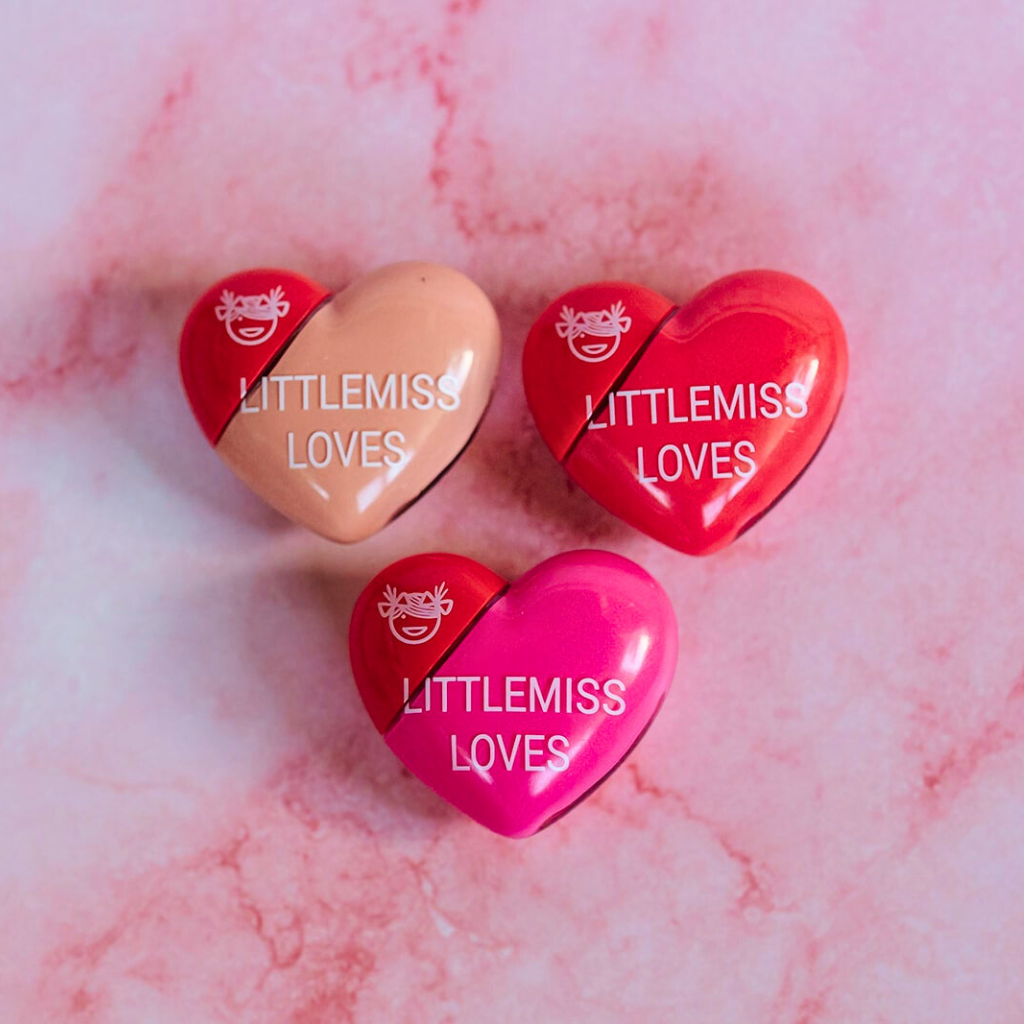 Heart-shaped 'LITTLEMISS LOVES' products on a pink marble background
